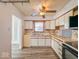 A well-lit kitchen featuring wooden cabinets, neutral countertops, and updated appliances at 1239 Brooks St, Indianapolis, IN 46202