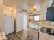 A functional kitchen features white cabinets and neutral countertops at 1239 Brooks St, Indianapolis, IN 46202