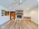Bright living room featuring a stone fireplace, built-in shelving, and wood-look floors at 1239 Brooks St, Indianapolis, IN 46202