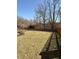 A large backyard with lawn surrounded by wooden fences and trees at 12461 Hawks Landing Dr, Fishers, IN 46037