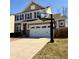 Charming two-story home with stone accents, two car garage and basketball hoop at 12461 Hawks Landing Dr, Fishers, IN 46037