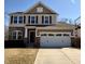 Charming two-story home with stone accents, red shutters and a two car garage at 12461 Hawks Landing Dr, Fishers, IN 46037