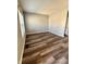 View of the empty living room with sleek wood floors and bright natural light at 12461 Hawks Landing Dr, Fishers, IN 46037
