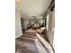 View of the staged living room with sleek wood floors, ceiling fan and sliding glass doors at 12461 Hawks Landing Dr, Fishers, IN 46037