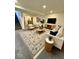 A fully furnished living room with carpet, stylish sofa, chairs and decor at 12461 Hawks Landing Dr, Fishers, IN 46037