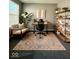 A stylish home office space with a wooden desk, comfortable chair, and shelving unit at 12461 Hawks Landing Dr, Fishers, IN 46037