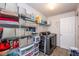 Organized laundry room with ample shelving, modern washer and dryer, and clean design at 13414 Allegiance Dr, Fishers, IN 46037