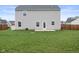 The home's backyard boasts a well-kept lawn, patio, and stylish vinyl siding at 13860 N Tiosa Ln, Camby, IN 46113