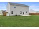 Rear view of a two-story house showing the backyard, patio, and vinyl siding at 13860 N Tiosa Ln, Camby, IN 46113