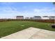 Spacious backyard with a lush lawn, a concrete patio, and a wooden fence at 13860 N Tiosa Ln, Camby, IN 46113