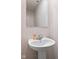 A quaint bathroom showcases a pedestal sink and a large mirror at 13860 N Tiosa Ln, Camby, IN 46113