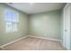 Well-lit bedroom with plush carpet, a window with blinds, and light green walls at 13860 N Tiosa Ln, Camby, IN 46113