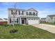 Two-story home with a two-car garage, neutral siding, and a well-manicured lawn at 13860 N Tiosa Ln, Camby, IN 46113