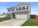 Charming two-story home with gray siding, black shutters, and a two-car garage at 13860 N Tiosa Ln, Camby, IN 46113