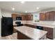 Well-lit kitchen with dark cabinetry, an island, and modern appliances at 13860 N Tiosa Ln, Camby, IN 46113
