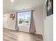 Inviting living area with wood-look floors and natural light from a large window at 13860 N Tiosa Ln, Camby, IN 46113