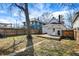 Landscaped backyard with a wooden deck and mature trees providing shade at 139 S Ritter Ave, Indianapolis, IN 46219