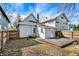 Back of home showing a wooden deck and mature trees in the backyard at 139 S Ritter Ave, Indianapolis, IN 46219