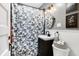 Charming bathroom with a modern vanity, stylish mirror, and a floral shower curtain at 139 S Ritter Ave, Indianapolis, IN 46219