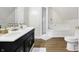 Elegant bathroom with double sinks, modern fixtures, tiled shower, and soaking tub at 139 S Ritter Ave, Indianapolis, IN 46219