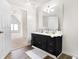 Bright bathroom with a black vanity with gold fixtures and a large mirror at 139 S Ritter Ave, Indianapolis, IN 46219