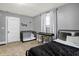 Bedroom features a comfortable bed, crib and a stylish black and white curtain at 139 S Ritter Ave, Indianapolis, IN 46219