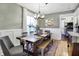 Bright dining room features a long wooden table with bench seating and neutral decor at 139 S Ritter Ave, Indianapolis, IN 46219
