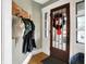 Welcoming foyer showcasing a wood door with sidelights, a coat rack, and hardwood floors at 139 S Ritter Ave, Indianapolis, IN 46219