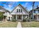 Charming home with a welcoming front porch and well-maintained lawn and landscaped garden beds at 139 S Ritter Ave, Indianapolis, IN 46219