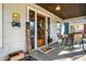 Inviting front porch with wood door, stylish seating, and decorative accents for a cozy outdoor space at 139 S Ritter Ave, Indianapolis, IN 46219