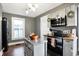 Charming kitchen features new stainless steel appliances and an abundance of natural light at 139 S Ritter Ave, Indianapolis, IN 46219