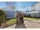 Grassy backyard with patio, fireplace, privacy fence, and string lights at 1413 S East St, Indianapolis, IN 46225