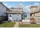 The house features a quaint backyard with a wooden deck, fire pit, and charming second story balcony at 1413 S East St, Indianapolis, IN 46225
