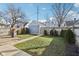 The backyard provides a green lawn, a fire pit, and a detached garage with well-maintained bushes at 1413 S East St, Indianapolis, IN 46225