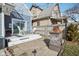 Inviting backyard patio with stylish table set, seating, and stone fireplace at 1413 S East St, Indianapolis, IN 46225