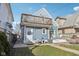 Backyard boasts a deck with patio seating, fire pit, lush green grass, and a balcony above at 1413 S East St, Indianapolis, IN 46225