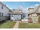 Enjoy this backyard with a wooden deck, fire pit, green lawn, and access to a balcony at 1413 S East St, Indianapolis, IN 46225