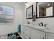 Well-lit bathroom featuring a double sink vanity with granite countertop and framed mirrors at 1413 S East St, Indianapolis, IN 46225