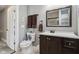 Bathroom features a dark wood vanity with white countertop, framed mirror and ceramic tile flooring at 1413 S East St, Indianapolis, IN 46225