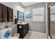 Bathroom features a dark wood vanity with white countertop, framed mirror and ceramic tile flooring at 1413 S East St, Indianapolis, IN 46225