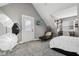 Bedroom with gray walls, soft carpet, desk with chair, and a door leading outside at 1413 S East St, Indianapolis, IN 46225