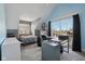 Bright, carpeted bedroom with a queen bed, work space, and natural light at 1413 S East St, Indianapolis, IN 46225