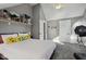 Bedroom with gray walls, soft carpet, and decorative shelving with a large bed with many pillows at 1413 S East St, Indianapolis, IN 46225