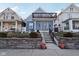 Charming two-story home featuring a unique second-story balcony and inviting curb appeal with landscaped front yard at 1413 S East St, Indianapolis, IN 46225