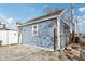 The detached garage features side doors, a small window, and the building number posted on the side at 1413 S East St, Indianapolis, IN 46225