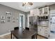 Bright kitchen featuring white cabinets, stainless steel appliances, and a dining table at 1413 S East St, Indianapolis, IN 46225
