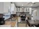 Updated kitchen boasts stainless steel appliances, white cabinetry, and butcher block countertops at 1413 S East St, Indianapolis, IN 46225