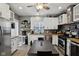 Modern kitchen showcasing white cabinets, a dining table and stainless steel appliances at 1413 S East St, Indianapolis, IN 46225