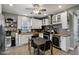 Well-lit kitchen featuring white cabinets, modern appliances, and a cozy dining area at 1413 S East St, Indianapolis, IN 46225