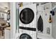 Laundry area with stacked washer/dryer and built-in storage shelves at 1413 S East St, Indianapolis, IN 46225